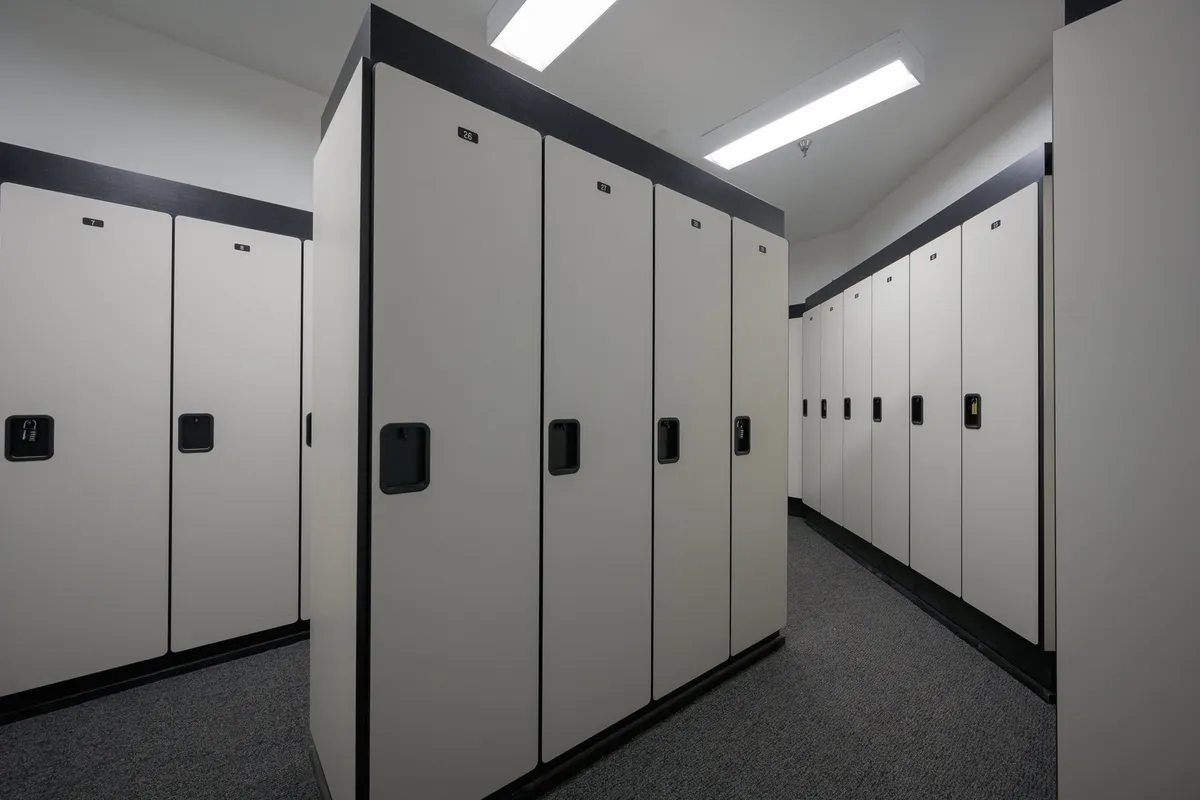 A well-lit locker area featuring modern lockers and lighting fixtures, suggesting a safe, organized space for storing skis, bikes, or other outdoor gear. The ambiance is neutral but welcoming, highlighting the functional side of community amenities.